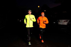 Two joggers wearing neon clothing or reflective clothing so that they can be seen